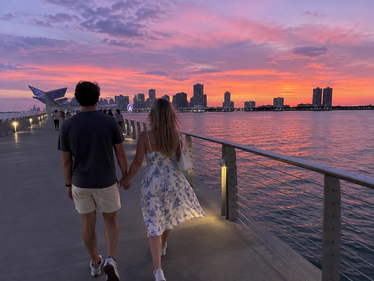 Couple walking along the water at dusk