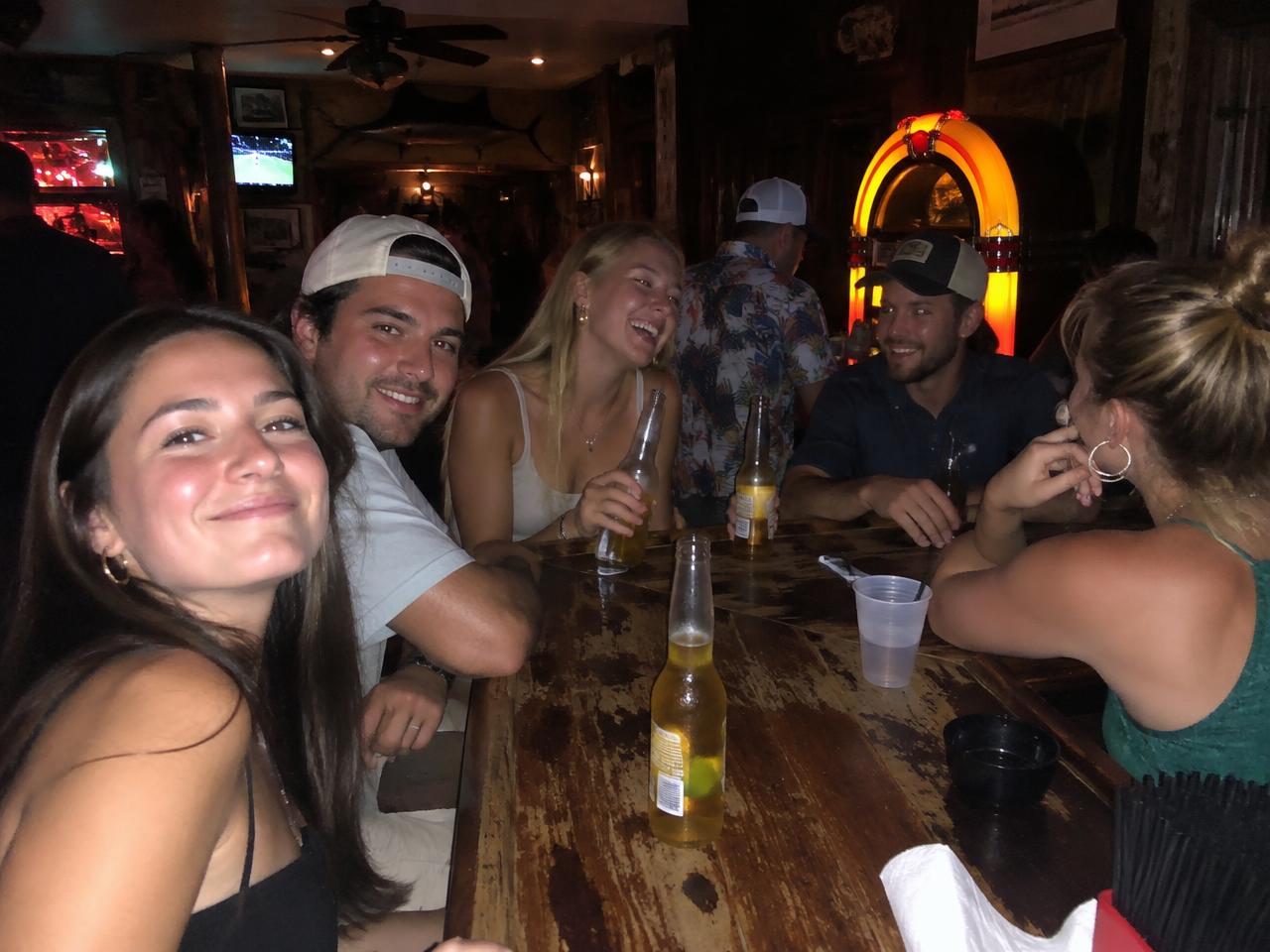 Friends at a wooden bar by the jukebox